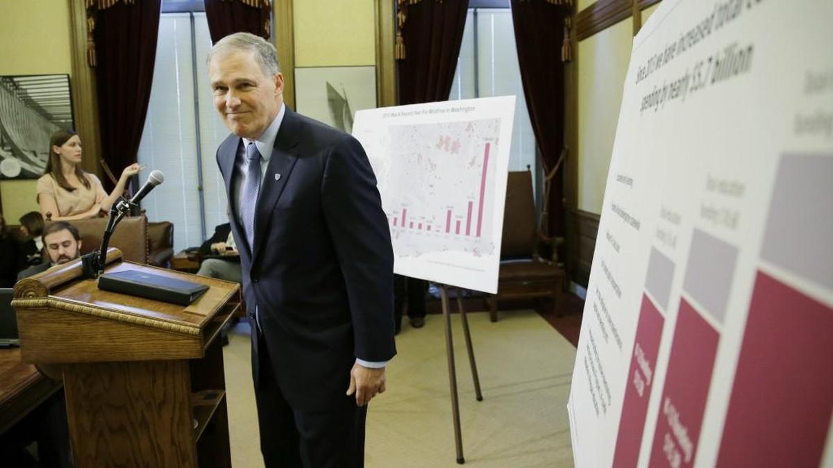 Washington Gov. Jay Inslee leaves the podium after talking about his proposed supplemental budget, plan, Thursday, Dec. 17, 2015, in Olympia, Wash.