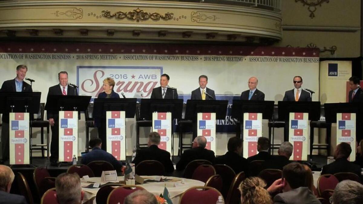 In this photo taken June 14, eight of the 11 candidates for Washington lieutenant governor take part in a debate in Spokane, Wash. From left, Marty McClendon, Paul Addis, Sen. Karen Fraser, D-Olympia, Sen. Steve Hobbs, D-Lake Stevens, Bill Penor, Javier Figueroa, Sen. Cyrus Habib, D-Bellevue, and Phillip Yin, all stand at their podiums. (AP Photo/Nicholas K. Geranios)