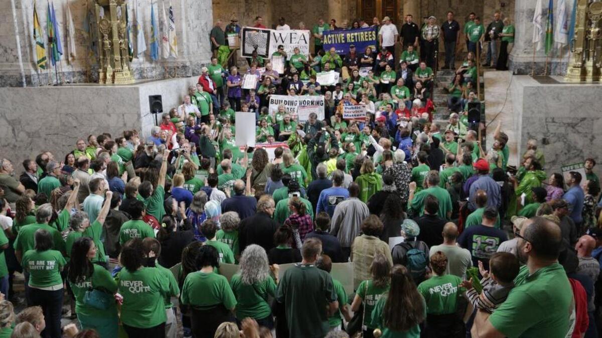 Union members and supporters rally at the Capitol Wednesday (Aug. 31) in Olympia. The state has reached tentative collective bargaining agreements with more than a dozen state worker unions, but negotiations continue with eight more, while another six are in arbitration.