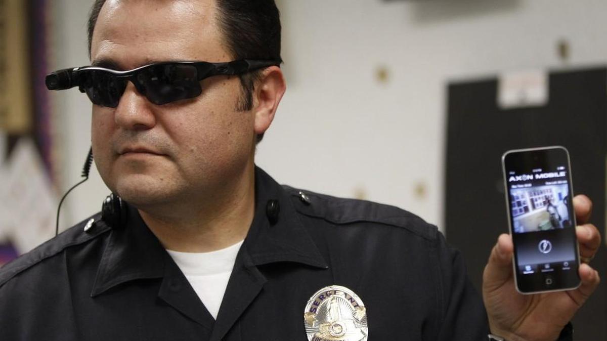 
Los Angeles Police Sgt. Daniel Gomez demonstrates a video feed from his camera into his cellphone as on-body cameras are demonstrated for the media in Los Angeles last year. In Washington state, adopting statewide standards for police body cameras continues to vex lawmakers.
