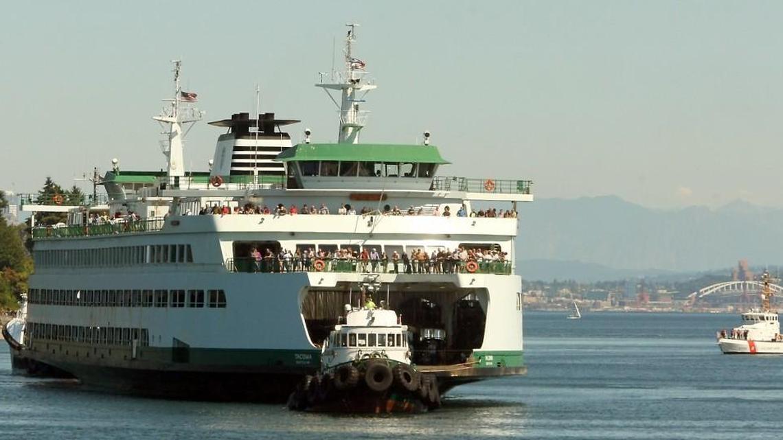 Tugboats bring the M/V Tacoma to dock after it lost power traveling from Seattle to Bainbridge Island in 2014.