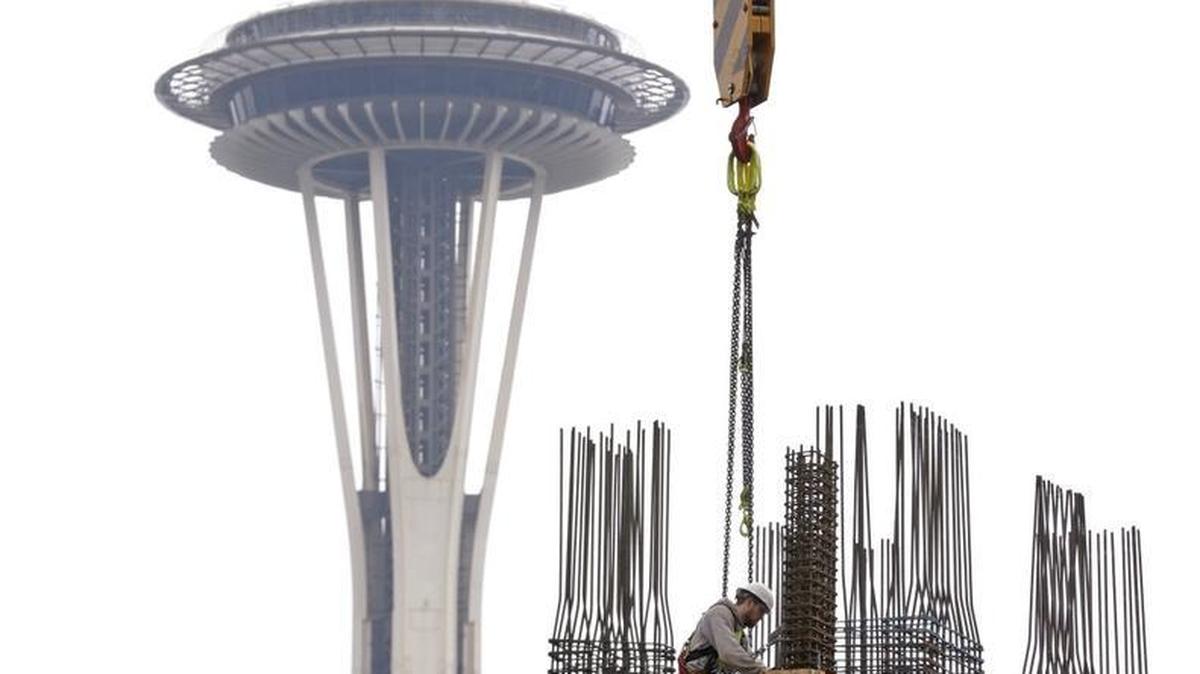 
In this photo taken Feb. 26, 2015, a construction worker puts in framing for a new high-rise building in view of the Space Needle in the South Lake Union neighborhood of Seattle. A booming real-estate market has helped boost state revenue.
