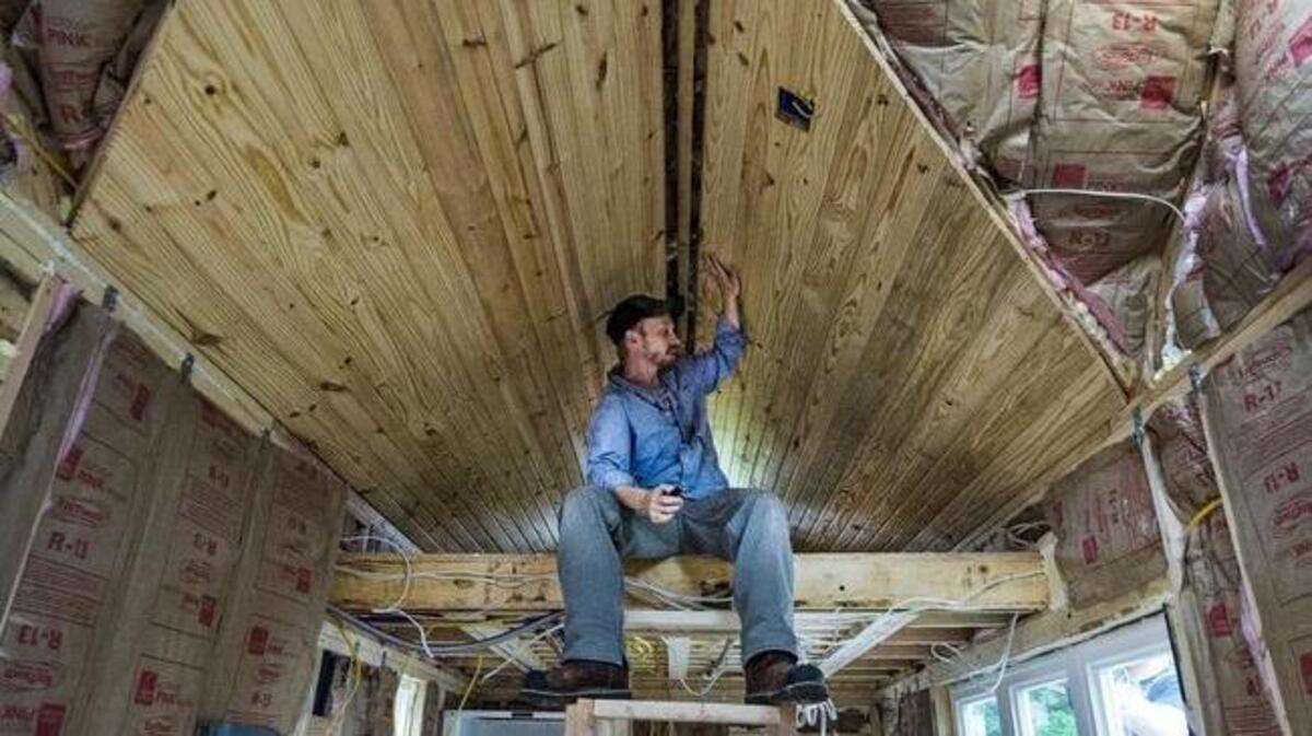 Mitch Trumpp, co-owner of Second Life Studios, checks some of the work inside a tiny house he was helping build in Kansas City in 2015. Some people are moving into tiny homes to encourage communal living and reduce the importance of possessions.