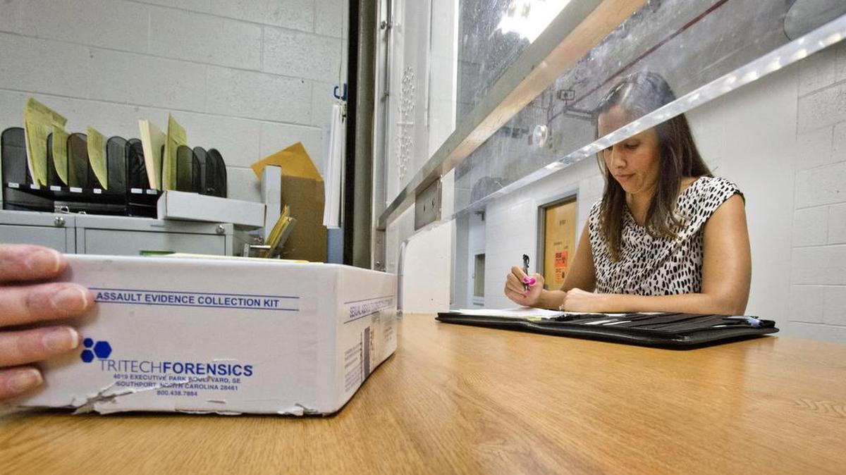 
In this file photo from February 2014, Tacoma Police Detective Lindsey Wade visits the property room in the basement of the County-City Building, where rape kits are held during investigations. 
