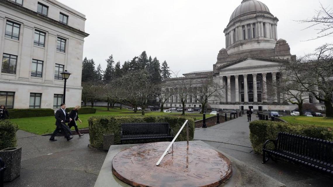 In this photo taken Jan. 9, 2014, the Legislative Building at the Washington state Capitol in Olympia, Wash., is shown as rain falls on the sundial in the foreground.