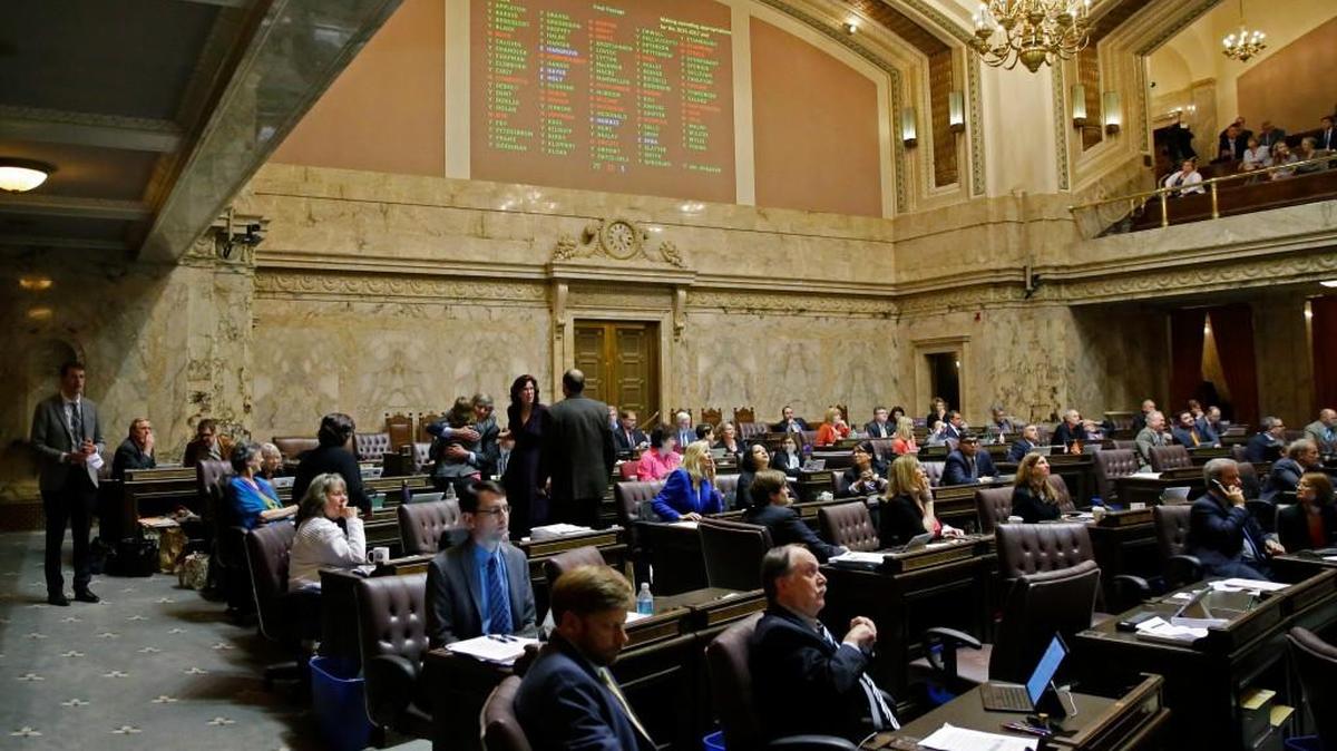 Voting results are projected above the House floor Friday after a vote on the state operating budget at the Capitol in Olympia,.