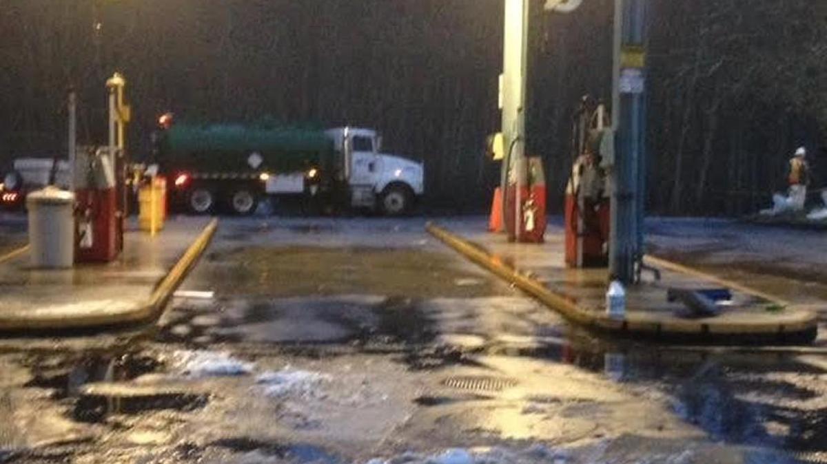 Olympia School District bus barn’s pump island, with contractor’s vacuum truck in background, where a fuel spill was reported Monday afternoon. Crews are cleaning up gasoline that went into a stormwater retention pond located behind the truck.