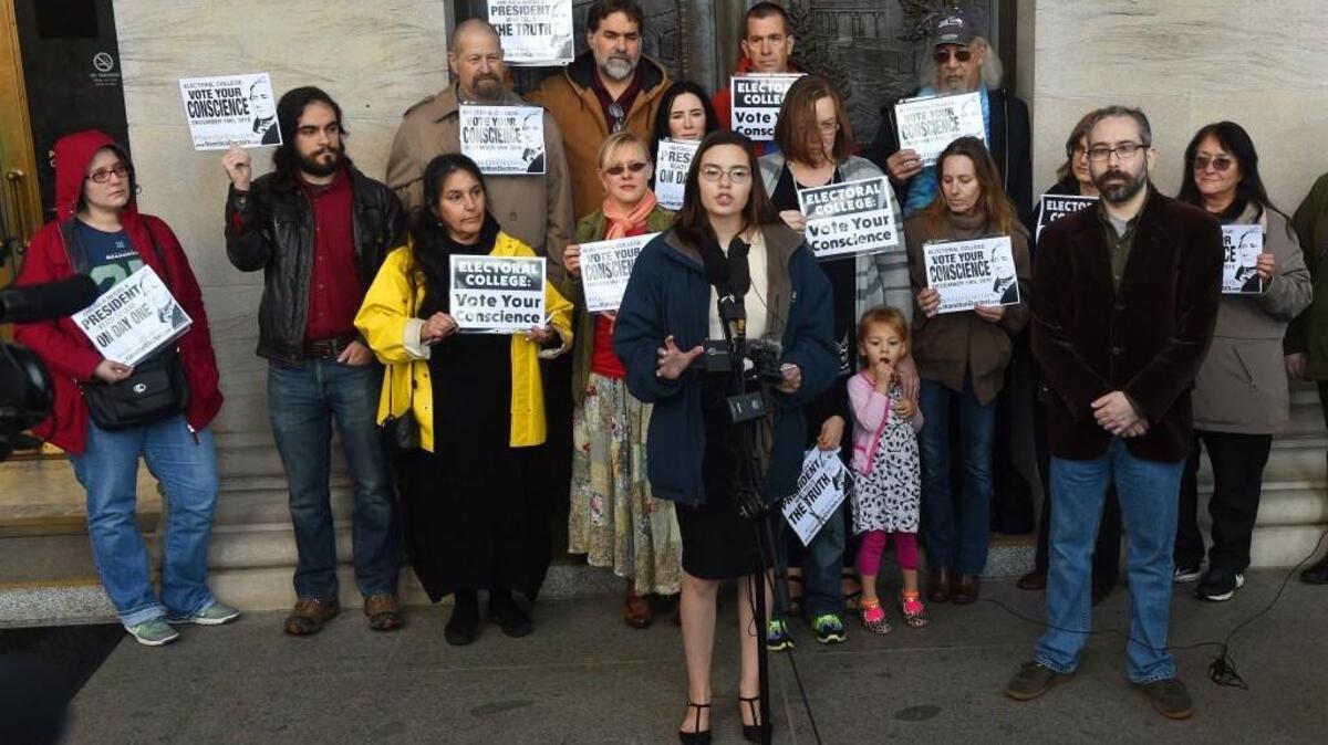 Speaking in front of the Legislative Building in Olympia, Washington state Presidential Electors Levi Guerra and Bret Chiafalo (right) announce that they're asking members of the Electoral College pick a Republican "consensus candidate" rather than Trump, when they decide the next president on Dec. 19.