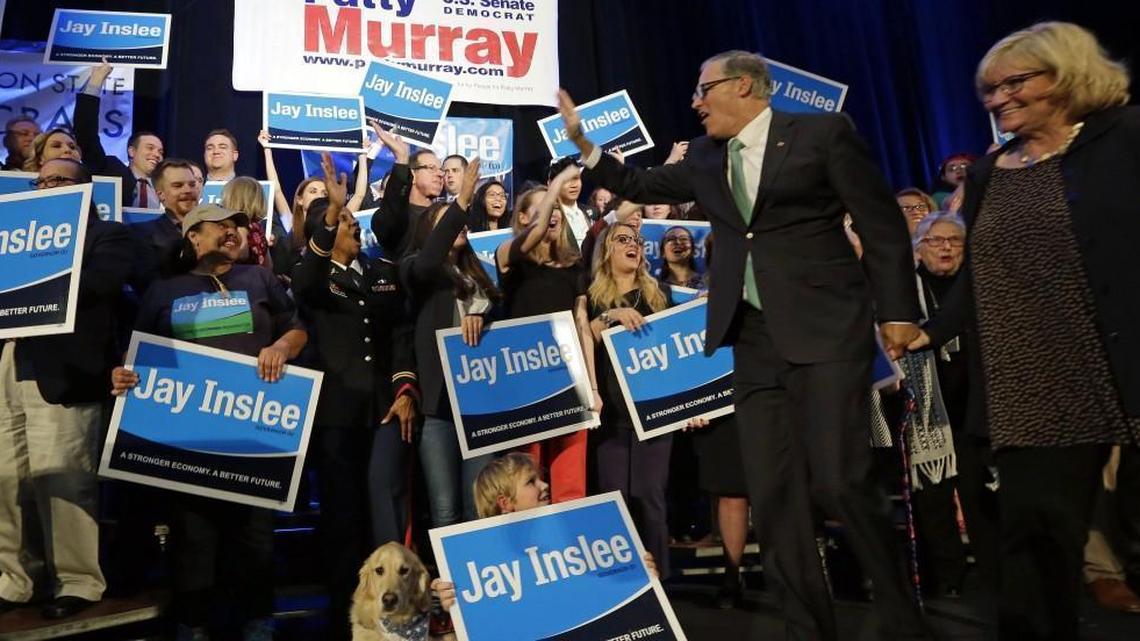 Gov. Jay Inslee waves to supporters as he heads on stage with his wife, Trudi Inslee, right, at an election night party for Democrats Tuesday, Nov. 8, 2016, in Seattle. Inslee defeated Republican challenger Bill Bryant to win re-election.