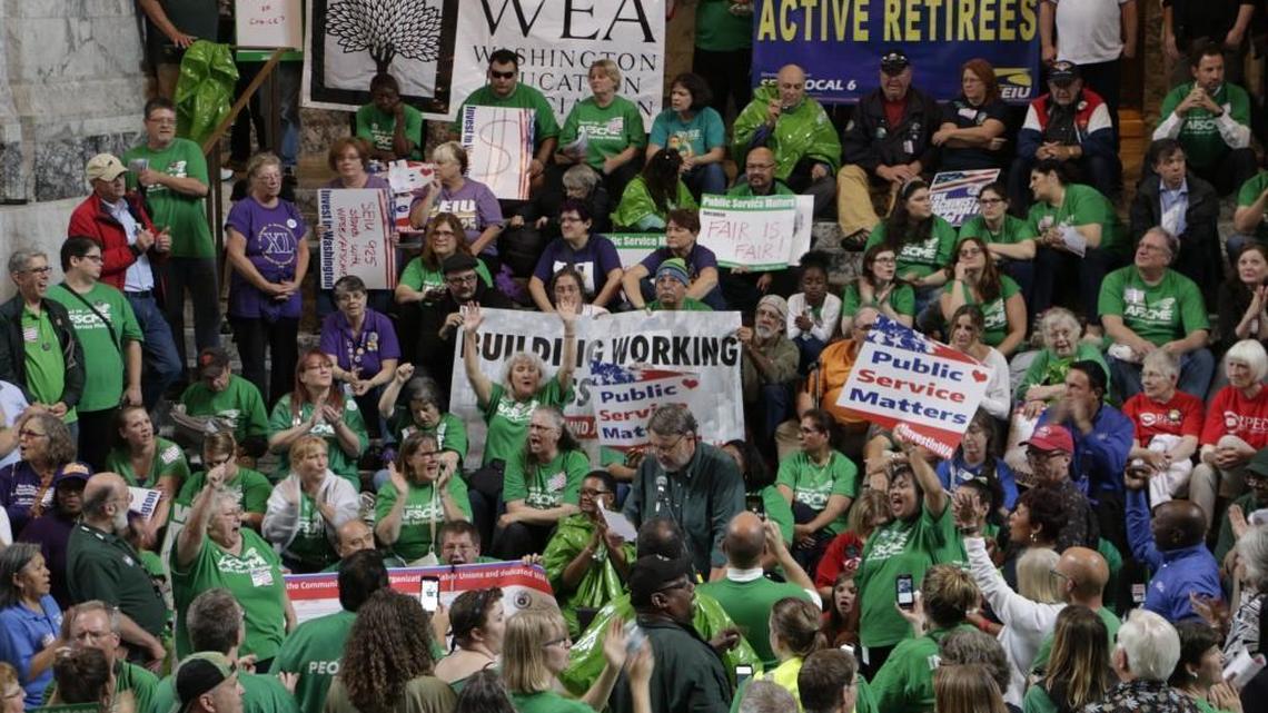 Union members and supporters rally at the Washington Capitol, Wednesday, Aug. 31, 2016, in Olympia. Most Washington state workers would receive 6 percent pay raises over two years under a tentative agreement reached Tuesday between state officials and union leaders.