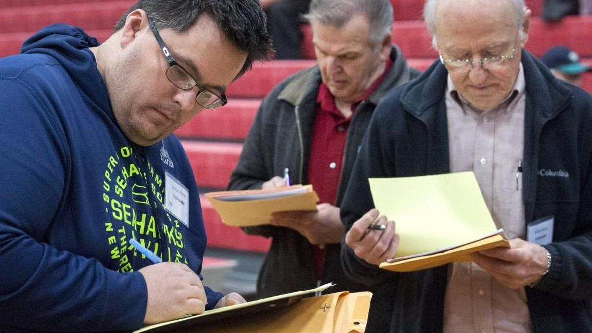 Zachary Palmer, left, and fellow Thurston County Republicans mark their ballots to select delegates to the state convention. Photo taken at Black Hills High in Tumwater on Saturday, March 19.