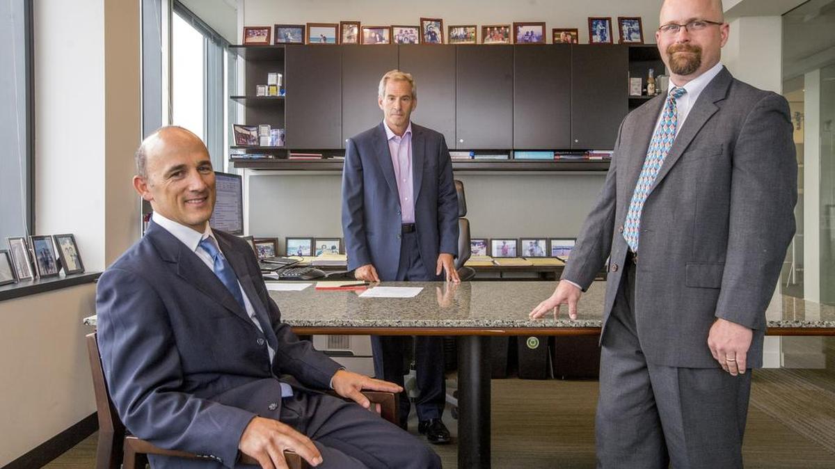 
Attorneys Tom Loeser (left), Steve Berman and Tyler Weaver in the Seattle office of Hagens Berman.  They sued on behalf of homeowners they said were charged illegal fees in real-estate transactions. Their lawsuits uncovered practices that are now the focus of criminal charges against Troy Kelley concerning Kelley’s business practices before becoming Washington State Auditor.
