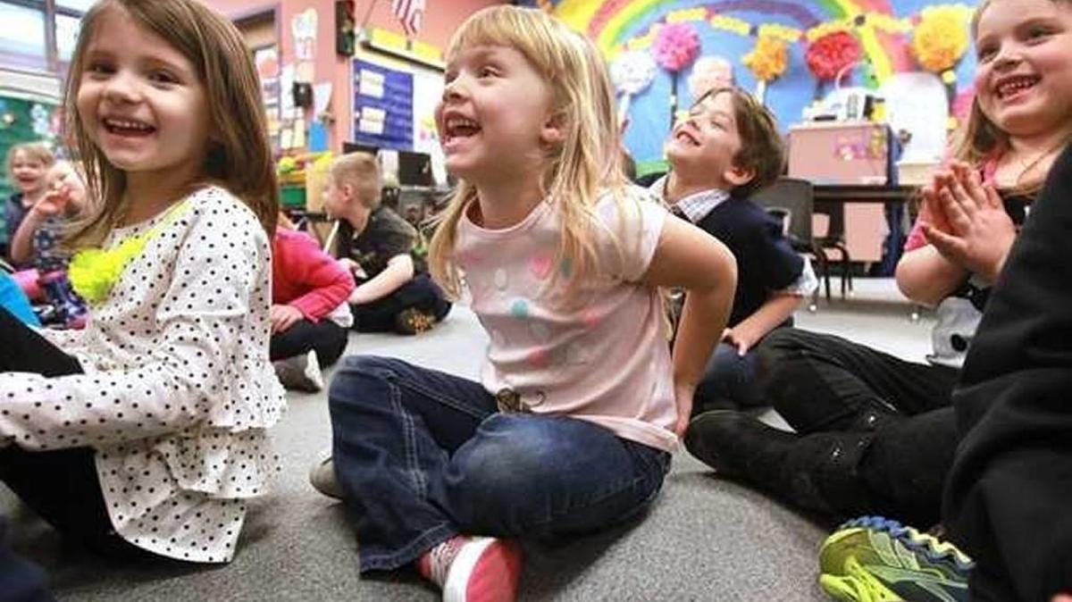In this file photo, Peyton Pierce, from left, Abby O’Brien, Jace Rose and Sophia Singleton sing along with teacher Kathe Fettig during their kindergarten class at McKenny Elementary in Olympia on Feb. 21, 2014.