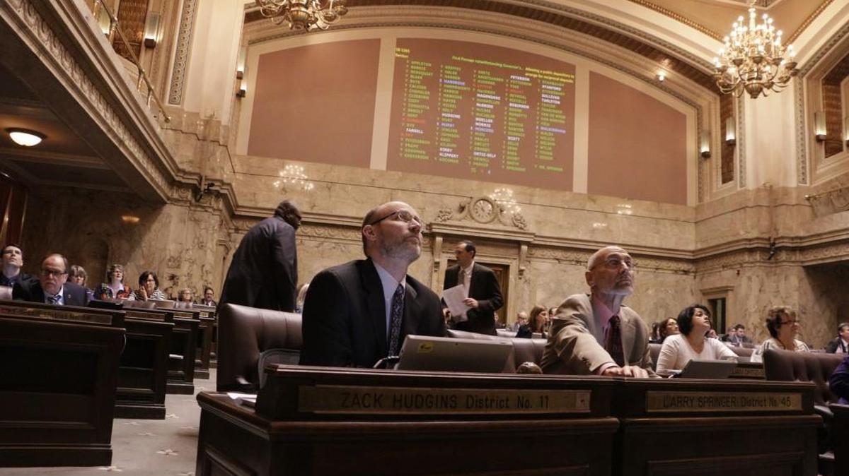 Lawmakers in the House watch the vote board during one of 27 votes to override gubernatorial vetoes, Tuesday, March 29, 2016, in Olympia, Wash. The last time the Legislature overrode a veto was in 1998.