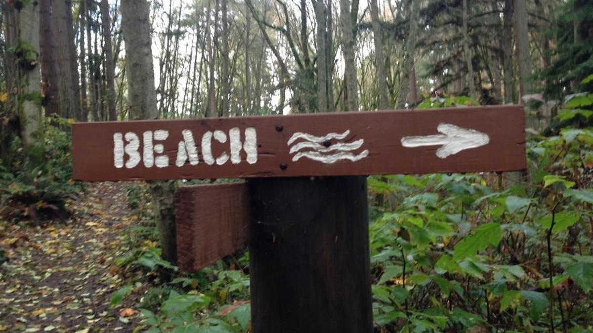 A sign points the way to Puget Sound at Dash Point State Park. A government shutdown would mean closure of parks across Washington.