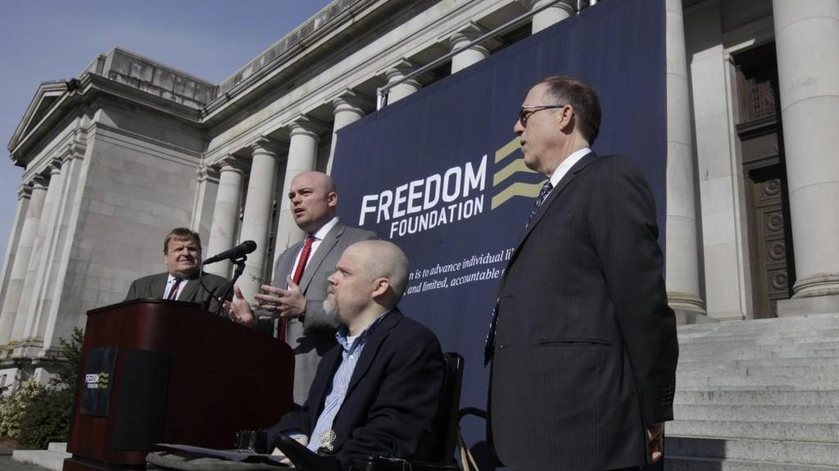 
Standing on the steps of the Temple of Justice in Olympia on March 5, Freedom Foundation litigation counsel David Dewhirst announces a lawsuit challenging the practice of making one union the sole representative of a category of workers. He is joined by Freedom Foundation CEO Tom McCabe, left, foundation general counsel James Abernathy and Milton Chappell of the National Right to Work Committee, right.
