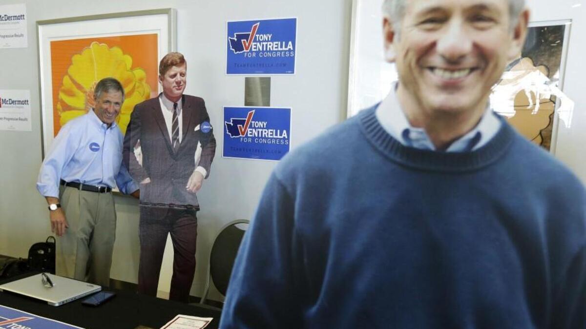Congressional candidate Tony Ventrella, left, poses for a photo with a life-size photo of John F. Kennedy as his own life-size image is displayed at right, June 17 at the state Democratic Convention in Tacoma. He has now left the race.