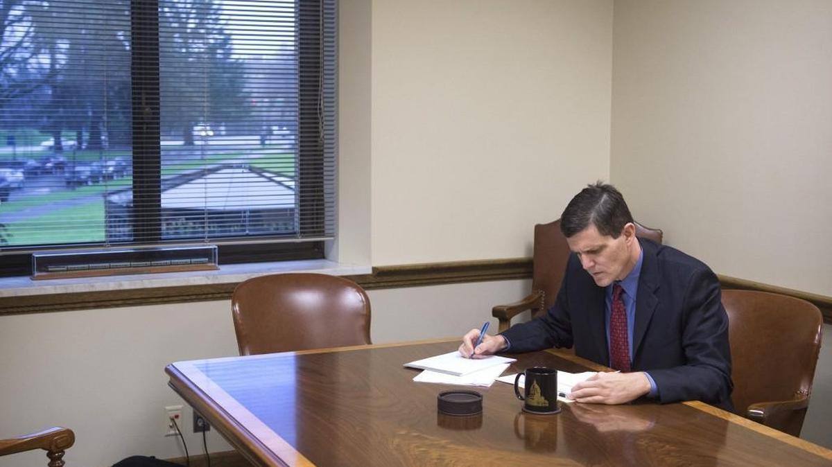 Washington State Auditor Troy Kelley looks over paperwork in the auditor’s conference room on the Capitol Campus in Olympia on Dec. 8, 2015.
