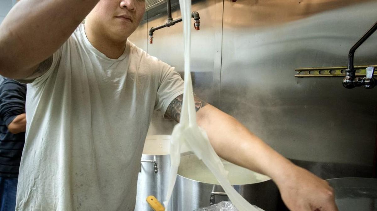 Owner Huy Tat unfolds fresh rice noodles after they are delivered earlier in the day at Hue Ky Mi Gia Chinese noodle house on Tuesday. He gets a fresh rice noodle delivery each day. Tat doesn’t refrigerate the noodles because he uses them right away and they don’t sit out long.