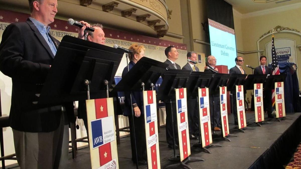In this photo taken June 14, 2016, eight of the 11 candidates for Washington lieutenant governor take part in a debate in Spokane, Wash. From left, Marty McClendon, Paul Addis, Sen. Karen Fraser, D-Olympia, Sen. Steve Hobbs, D-Lake Stevens, Bill Penor, Javier Figueroa, Sen. Cyrus Habib, D-Bellevue, and Phillip Yin, all stand at their podiums. The top two vote-getters in the Aug. 2, 2016 primary will advance to the Nov. 8, 2016, general election.