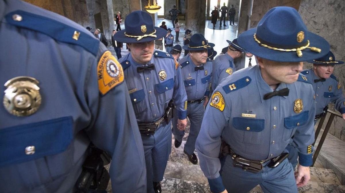 Washington State Patrol troopers and senior officers arrive for the Washington State Patrol new trooper graduation ceremonies in the state Capitol Rotunda in Olympia on Thursday, Nov. 19, 2015.