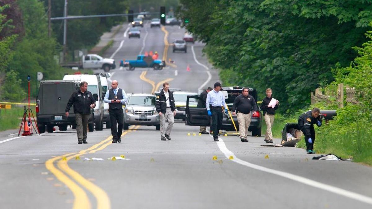 Investigators comb the scene of a May 21, 2015 officer involved shooting. Two young men were shot by an Olympia police officer during an altercation in west Olympia.