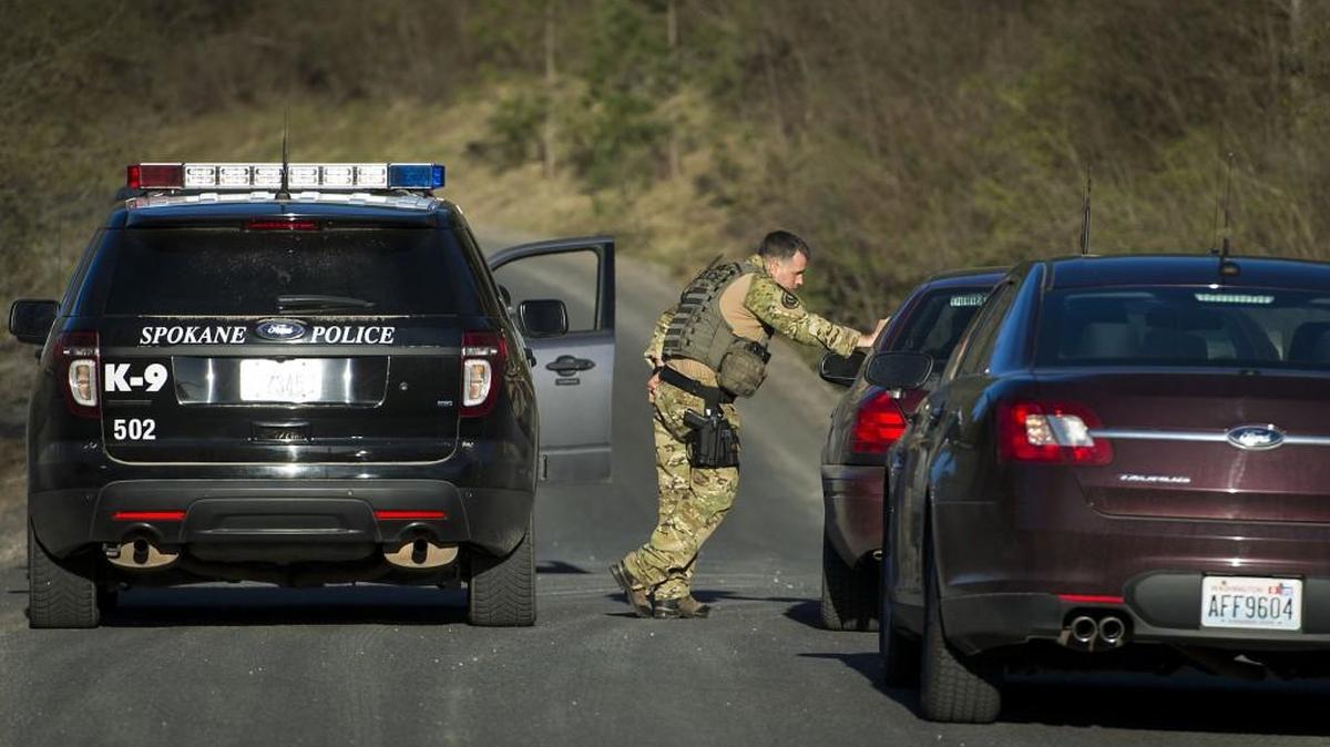 Officials stop vehicles as they search in Spokane Valley in April for escaped mental patient Anthony Garver.