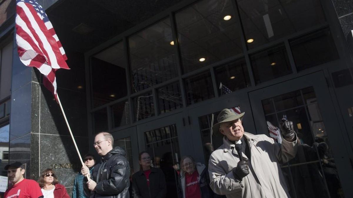 Rev. George Taylor, visitation pastor at All Saints Lutheran Church, speaks in favor of the Affordable Care Act Monday, Feb. 13, during a protest against the repeal of the law. The audience was a hundred people standing in front of the Peyton building, where Rep. Cathy McMorris Rodgers has her Spokane office.