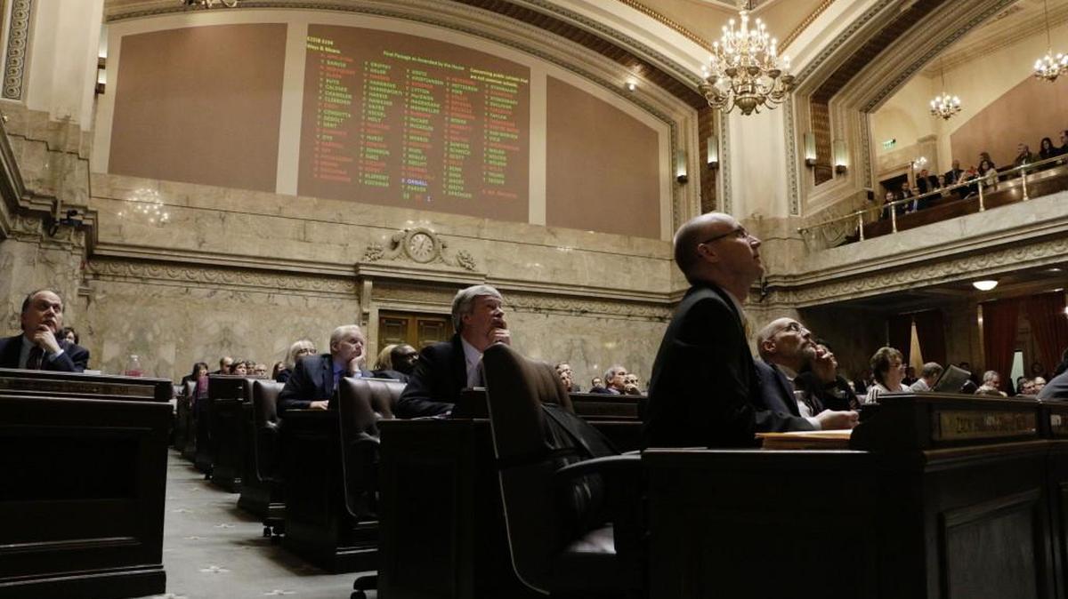 Lawmakers in the House of Representatives watch the electronic vote board during a vote on a bill that changes the funding source for the state's charter schools, Wednesday, March 9, 2016, in Olympia, Wash. The House passed the measure that seeks to save the schools, which have been in limbo since the state Supreme Court ruled in September that the charter school system is unconstitutional.