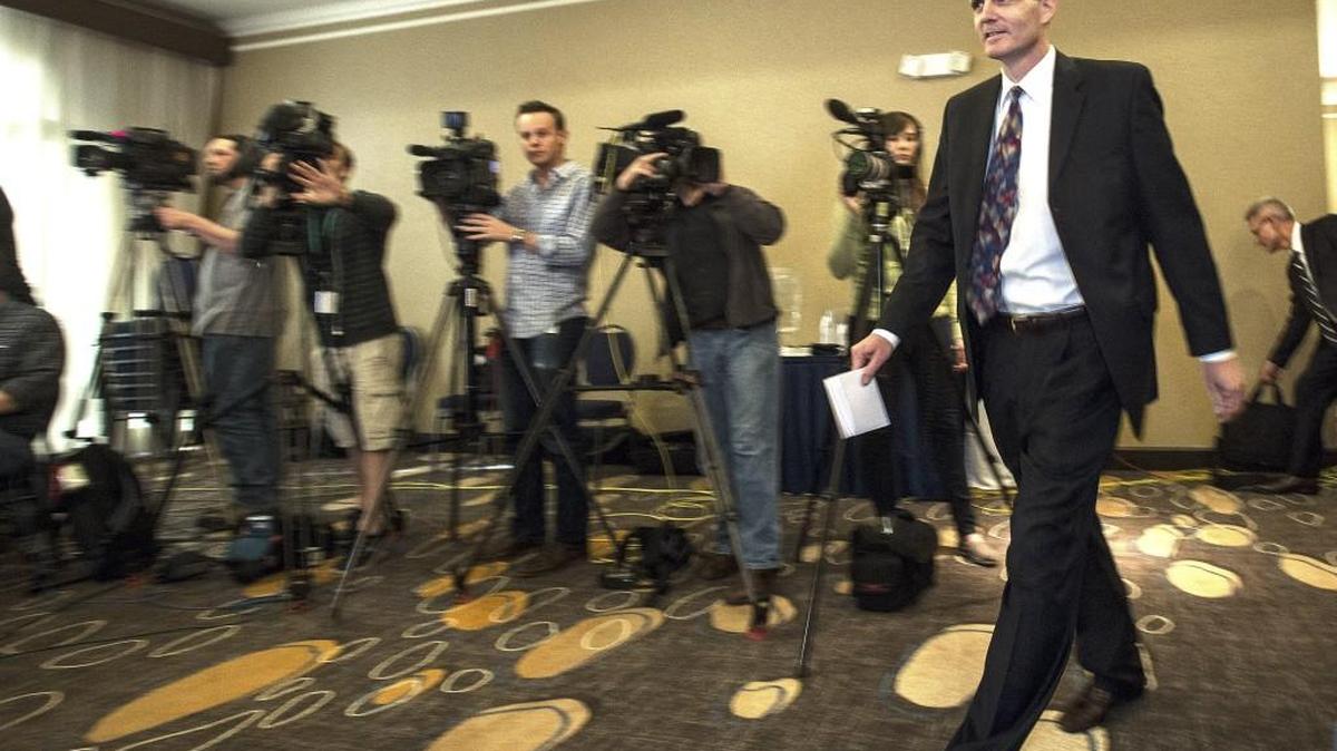 Washington State Auditor Troy Kelley walks past a row of news media before making a short statement during a press conference in downtown Tacoma April 16, 2015.