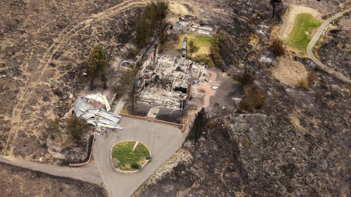 
The remains of structures that were destroyed by wildfires near Pateros are shown in July 2014. The fire was part of the Carlton Complex, the largest wildfire in Washington state history at the time.
