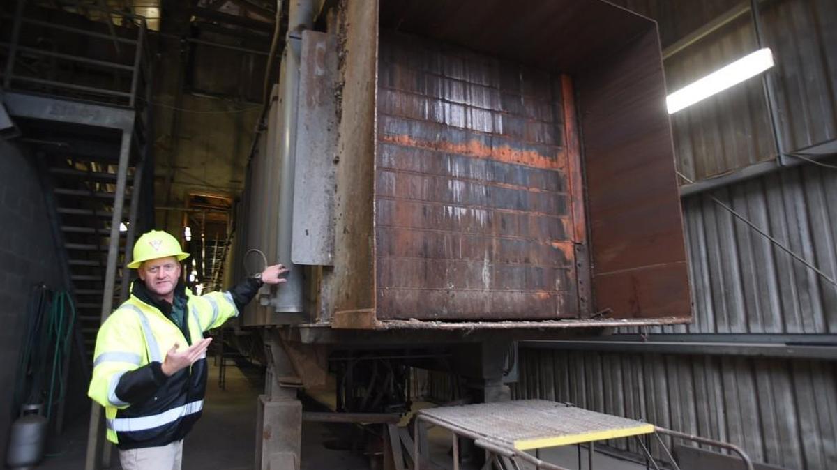 LeMay site manager John Cox explains the operation of the county’s idled compactor, which ceased to operate in June, during a tour last week of the Thurston County Transfer Station in Hawks Prairie.