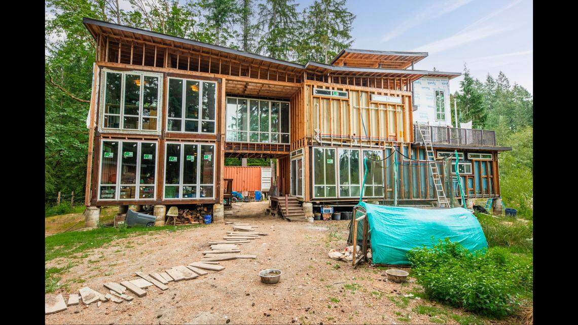 A partially-finished container home for sale near Seattle has three bedrooms, plus a secondary suite with another bedroom.
