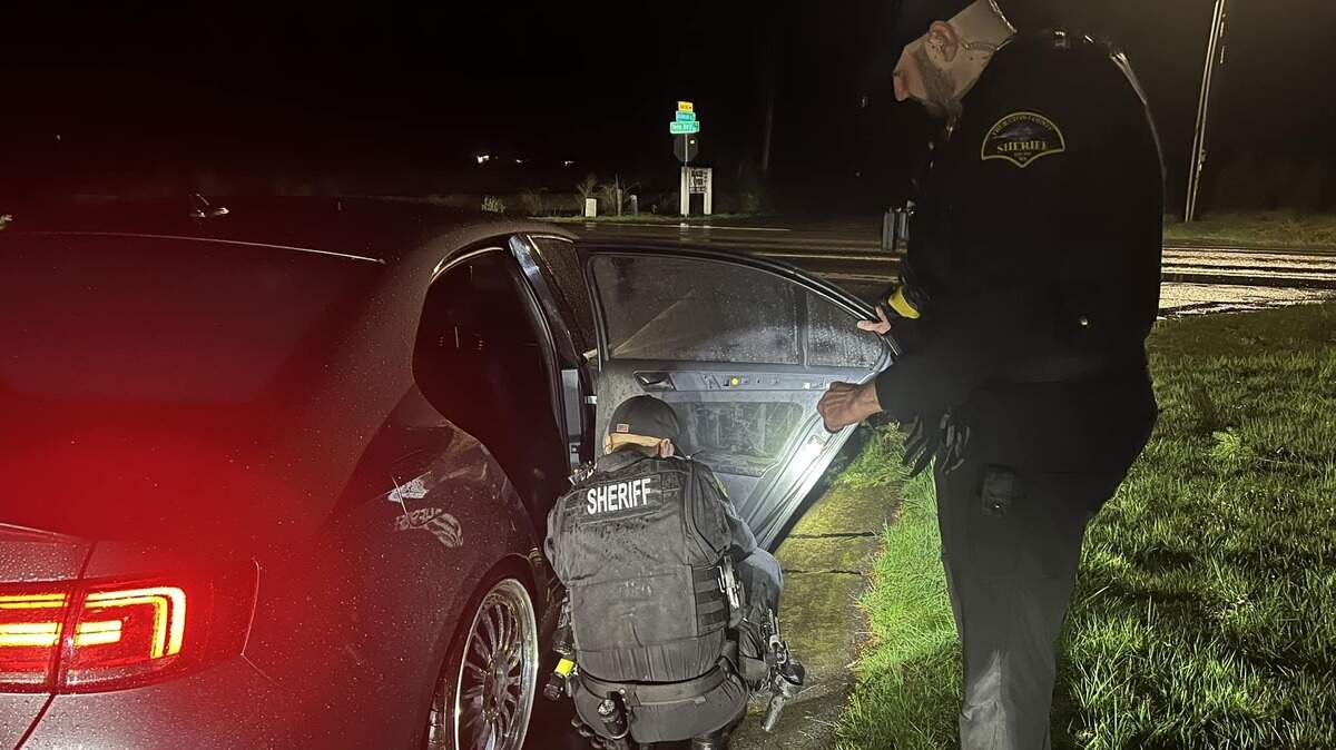 A patrol sergeant dismantles an interior door panel to gain access to one of the bullets that was shot at a vehicle Saturday night, according to the Thurston County Sheriff’s Office.