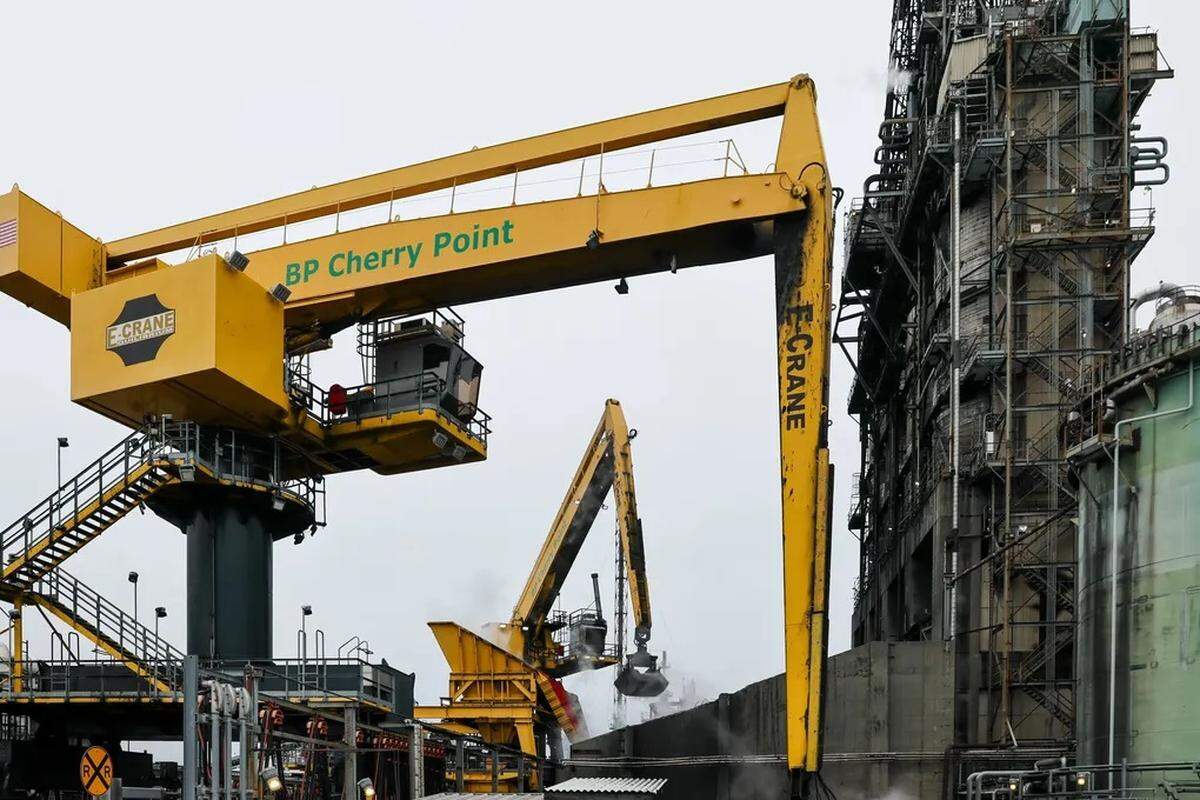 Cranes load coke for further refining at Cherry Point Refinery in Blaine on Oct. 19, 2023.