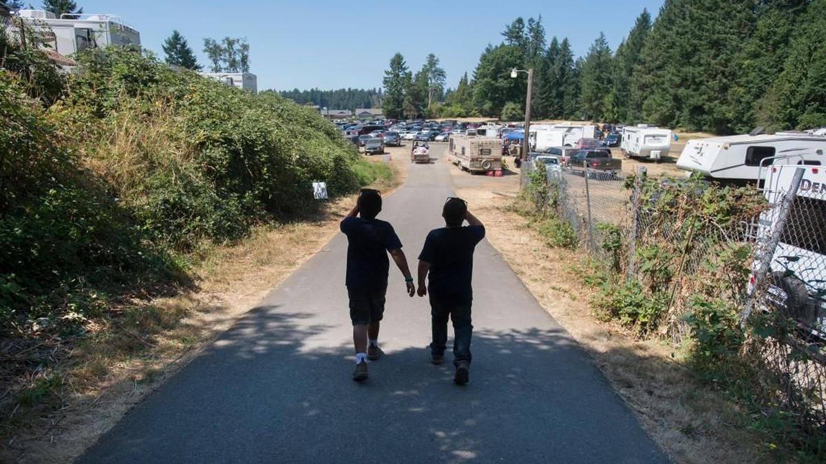 Two boys walk to their campsite at the Thurston County Fair on Saturday. This year’s fair coincided with a stretch of especially hot weather.