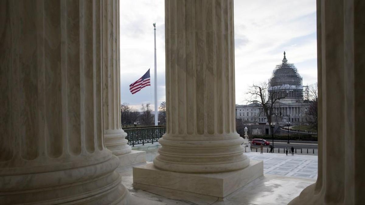 With the Capitol in the distance, the flag flies at half-staff at the Supreme Court in Washington, Wednesday, Feb. 17, 2016, in honor of Supreme Court Justice Antonin Scalia, who died last Saturday at age 79. Despite widespread insistence from the GOP-controlled Congress that President Barack Obama leave the decision to replace Scalia to the next president, Obama said Tuesday he had no intention of abdicating his responsibilities before leaving office early next year. He chidingly told the Senate he expects "them to do their job as well."