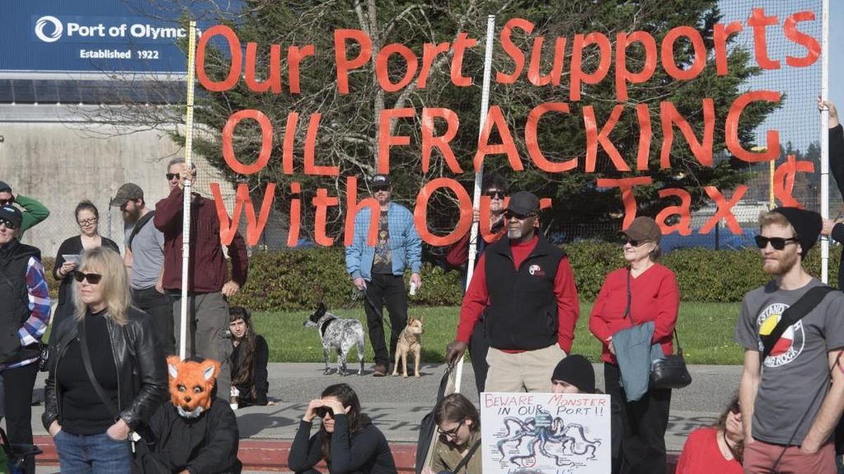 Opponents to the Port of Olympia’s acceptance of “fracking sand” shipments listen to speakers during a protest against the hydraulic fracturing oil industry at the Port Plaza on the Olympia waterfront on Oct. 22, 2016.