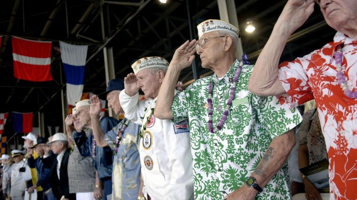A line of Pearl Harbor survivors salute during taps while participating at a Pearl Harbor Commemoration in Pearl Harbor, Hawaii, Sunday, Dec. 7, 2008.