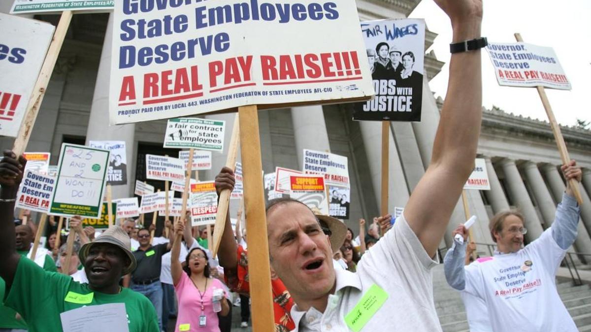 Luis Prado of Olympia, a graphic designer with the Deparment of Natural Resources, cheers along with about 300 fellow state union members to ask for higher wages during a rally on the Capitol steps in 2008.