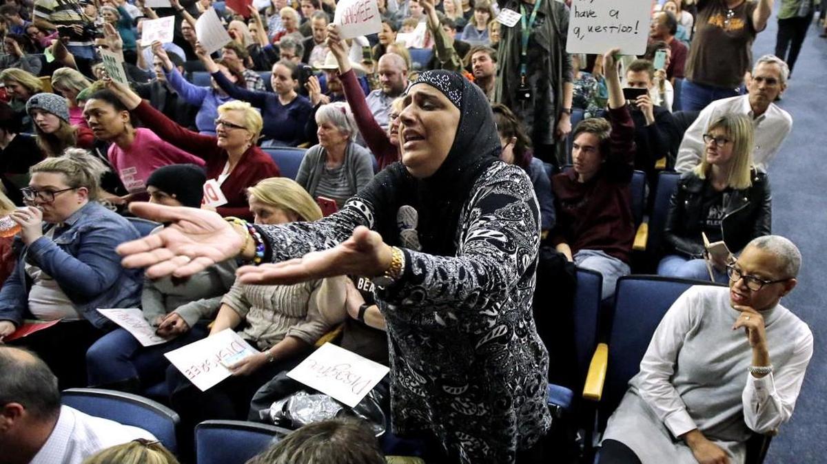 Noor Ul-Hasan reacts during Rep. Jason Chaffetz's town hall meeting