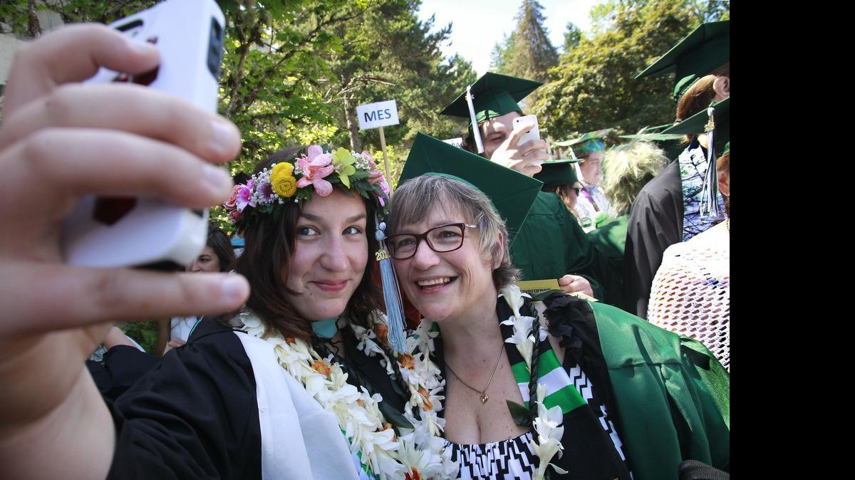 
Evergreen Masters in Teaching graduate Beth Chapin snaps a selfie photo of her and her mother, Bachelor of Arts graduate Jesi Chapin, as they wait for the start of commencement ceremonies at The Evergreen State College in Olympia on June 12, 2015. Under Senate Bill 5954, tuition rates will be cut by 5 percent next school year at TESC. 
