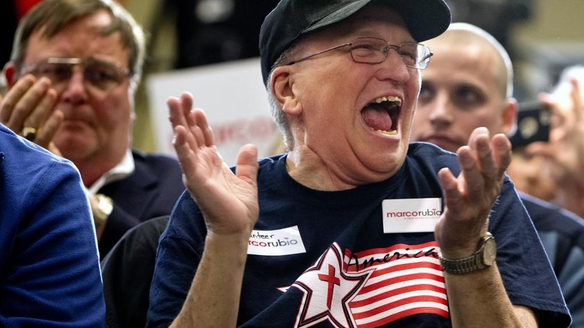 Joe Borgkvist, Jr., 72, of West Columbia, S.C., claps and laughs after shouting out that Republican presidential candidate Sen. Marco Rubio, R-Fla., should be the Republican nominee, as Rubio speaks at a campaign event in Columbia, S.C., Wednesday Feb. 10, 2016.