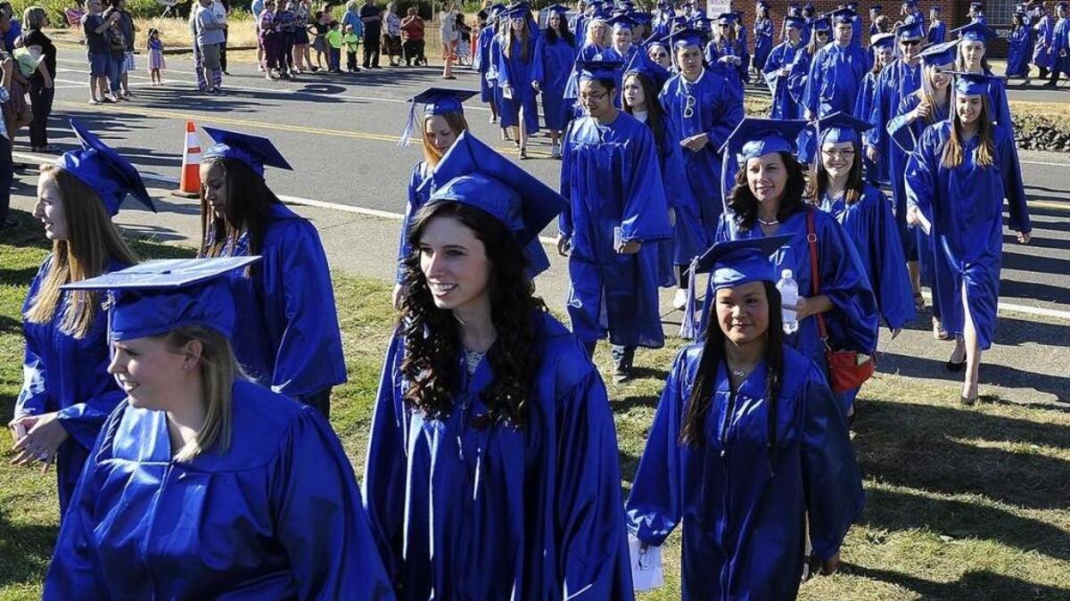 Graduates make their way from the gymnasium for their traditional walk to the athletic fields to begin the 2015 Commencement exercises at South Puget Sound Community College