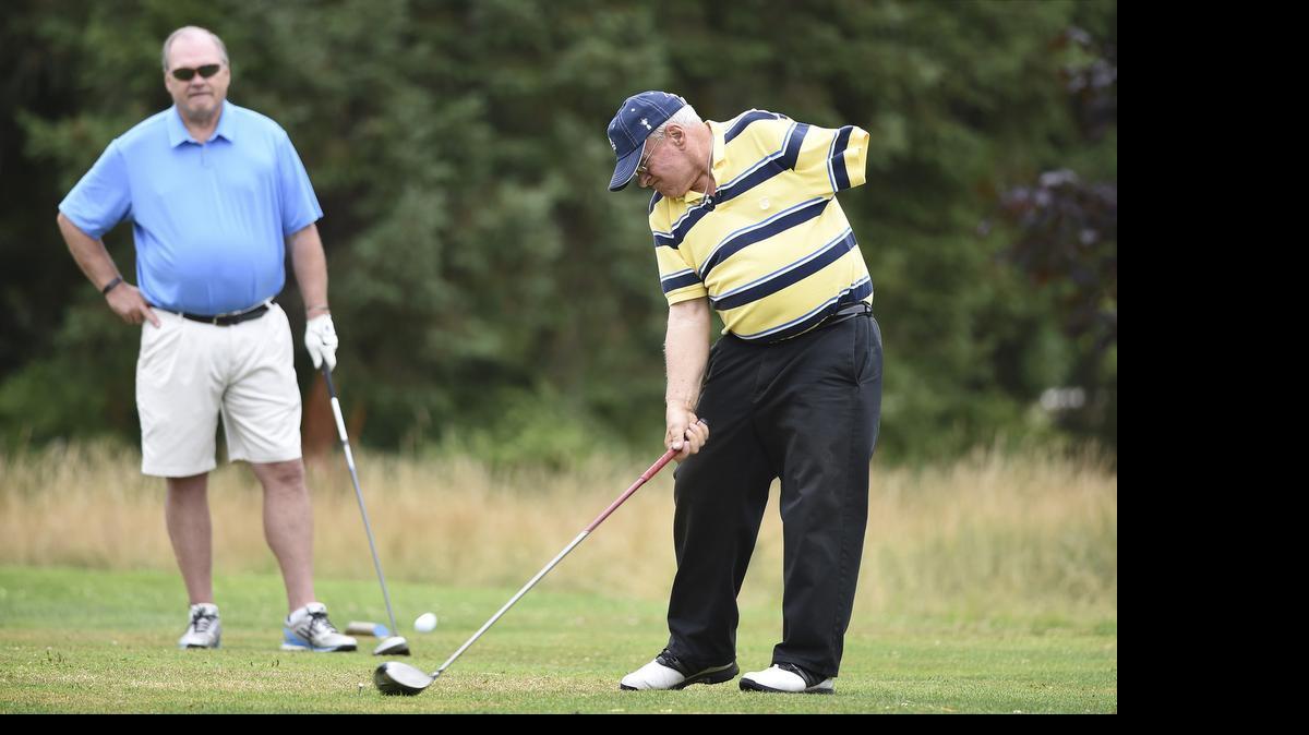 
Keith Kincy of Olympia tees off on the 16th hole at Tumwater Valley Golf Course in front of partner Mike Hermsen during the Mid-Washington Seniors & Washington Senior Games golf tournament on Wednesday. Kincy, 80, is a former 3-handicap golfer who lost his left arm in an industrial accident 21 years ago. “I won’t quit until they haul me off on a gurney,” Kincy said. The Washington State Senior Games, which kicked off with golf on Wednesday, continues through Sunday with sporting events throughout the South Sound. More information about when and where to watch events is available at www.washingtonstateseniorgames.com.
