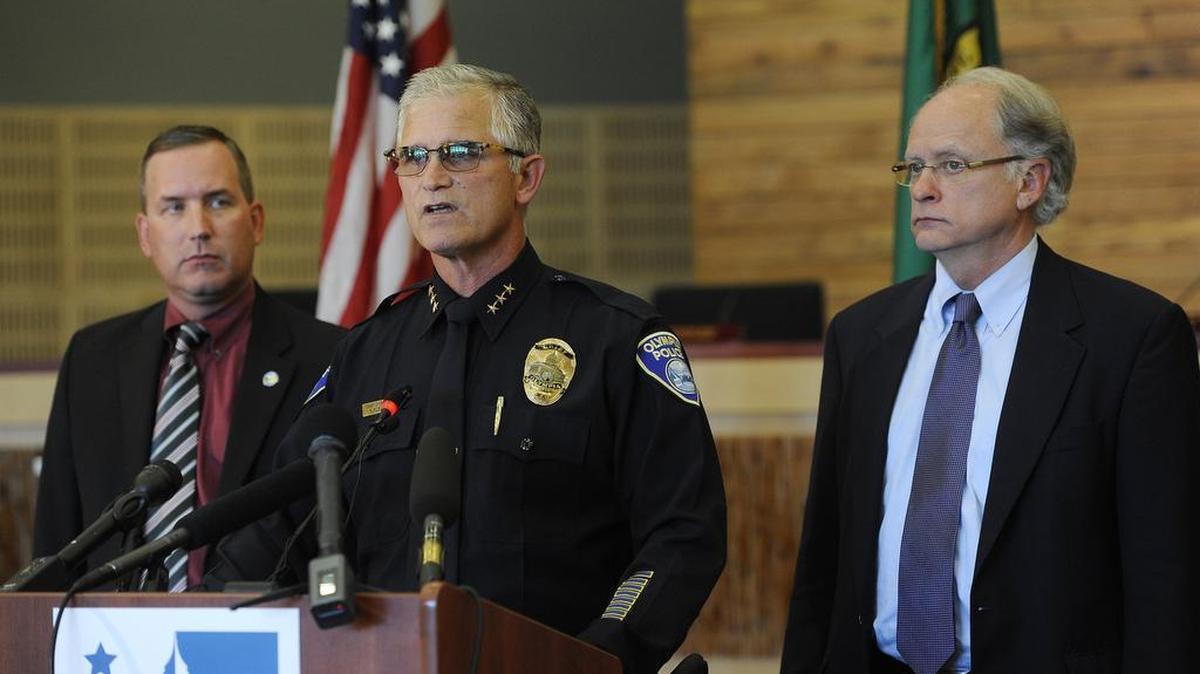 
Flanked by Mayor Stephen Buxbaum (right) and Asst. City Manager Jay Burney Olympia Police Chief Ronnie Roberts announce an internal departmental review of the May shooting incident by Officer Ryan Donald. Earlier Thurston County Prosecutor Jon Tunheim announced that Olympia Police Officer Ryan Donald will not face criminal charges for shooting two skateboarders after responding to a May 21 supermarket theft call.
