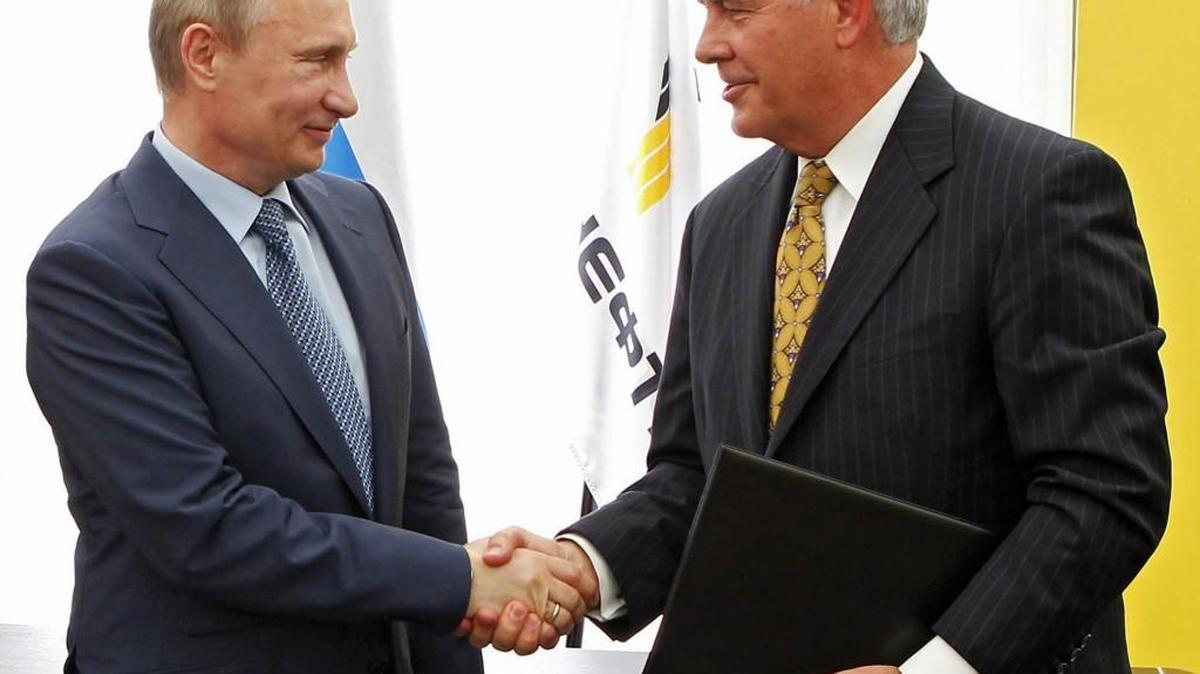 Russian President Vladimir Putin, left, and ExxonMobil CEO Rex Tillerson, now secretary of state-designate, shake hands at a signing ceremony of an agreement between state-controlled Russian oil company Rosneft and ExxonMobil at the Black Sea port of Tuapse, southern Russia.