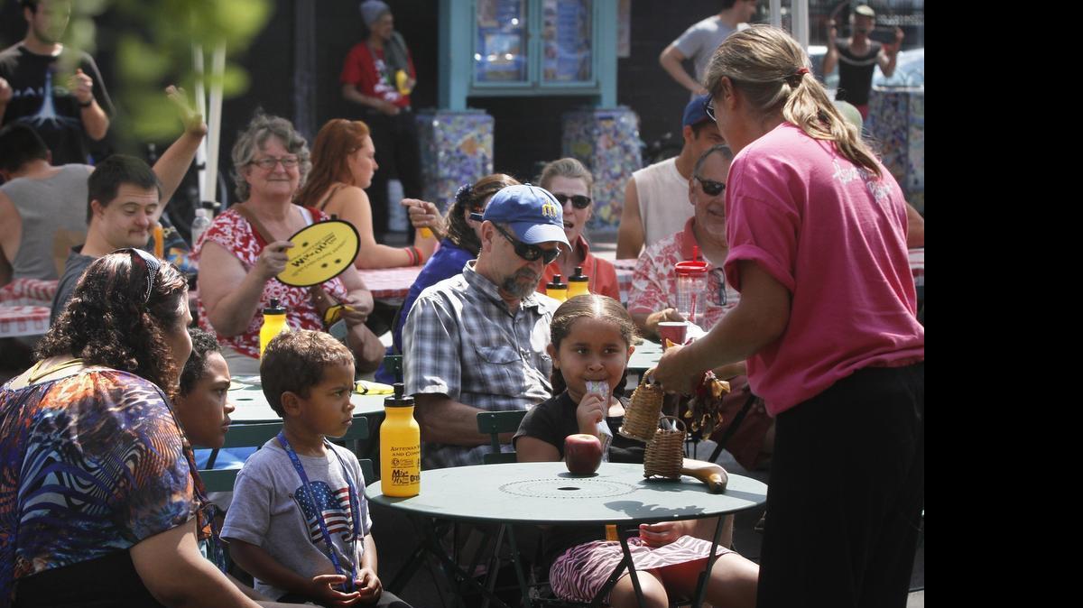 
FILE: Families wait for the start of the Heartsparkle Players performance during the "Play at the Well" activities day at the Artesian Commons in downtown Olympia on Saturday, Aug. 2, 2014.
