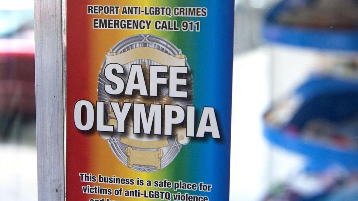 
Owners of the toy and book store Captain Little displays a sticker in its front window to show they participate in the Safe Olympia program, in which local businesses designate their stores as safehavens for LGBTQ victims of hate crimes.
