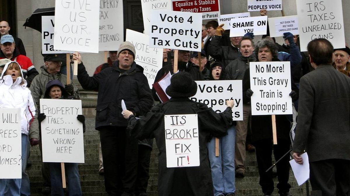 Greg Taylor (left center), of Port Angles, takes part in a demonstration against property taxes on the steps of the state capital as the Legislative session kicks off it's 60 day session in 2008. Property taxes continue to be discussed in the legislature this year.